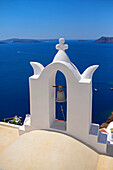 Church bell and hillside buildings in Oia, Santorini, Greek Islands, Greece
