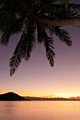 Sunset glow over ocean at Matangi Private Island Resort, Fiji.