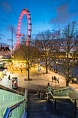 Christmas Market in Jubilee Gardens, with The London Eye at night, South Bank, London, England