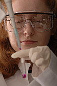 Scientist fills test tube in laboratory