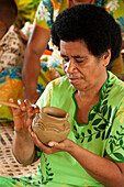 Woman making traditional pottery in Lawai village, Viti Levu Island, Fiji.