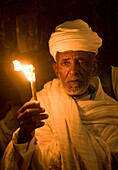 Ethiopian Orthodox worshiper hold candeles during the Holy fire ceremony at the Ethiopian section of the Holy Sepulcher in Jerusalm Israel
