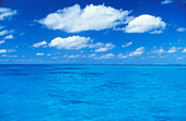 Ocean water, sky and white puffy clouds; Tanapag Lagoon, Saipan, Northern Marianas Islands.