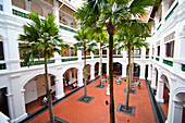 Tourists and Guests Shopping at Raffles Courtyard, Singapore. Raffles hotel is the most luxurious, up market hotel in Singapore. With Raffles City shopping mall home to shops such as Rolex and boasting no less that 12 different restaurants and bars, guests barely need leave the hotel. It is a popular place for tourists to shop and or enjoy afternoon tea if your purse strings can stretch a little.