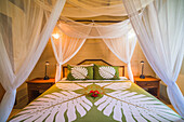 Four poster bed in a bedroom at Luxury Villa and hotel accommodation, Titikaveka, Rarotonga, Cook Islands, South Pacific