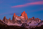 The Fitz Roy Massif in pastel pre-dawn morning twilight. Los Glaciares National Park near El Chalten, Argentina. A UNESCO World Heritage Site in the Patagonia region of South America. Mount Fitz Roy is in the tallest peak in the center.