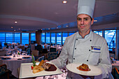 Stefan Berndt, the executive chef of Paul Gauguin show some dishes of the restaurant, 2-star Michelin. Paul Gauguin cruise, Society Islands, Tuamotus Archipelago, French Polynesia, South Pacific.