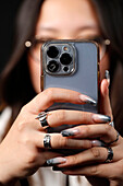 Female hand with smartphones close up, young woman using mobile phone, Instagram, Tik Tok and Facebook, France, Europe