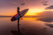 View of surfboarder on Kuta Beach at sunset, Kuta, Bali, Indonesia, South East Asia, Asia