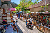 Motorcycles and souvenir stalls on street in Ubud, Ubud, Kabupaten Gianyar, Bali, Indonesia, South East Asia, Asia