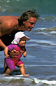 Man Playing With Baby In Ocean