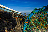 View To Lindisfarne Castle On Holy Island With Fishing Nets In The Foreground.