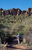 Man Hiking Towards Plateau, Rear View