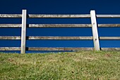 Fence By Pasture Against Blue Sky