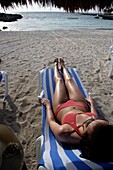 Junge Frau im Bikini beim Sonnenbaden am Strand der Maya-Riviera, Yucatan-Halbinsel, Staat Quintana Roo, Mexiko