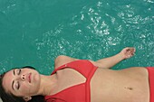 Young Woman Sunbathing By Swimming Pool, Mayan Riviera,Yucatan Peninsular,Quintana Roo State,Mexico