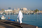 Man In Traditional Gown And Doha Bay Skyline, Doha,Qatar