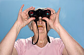 Senior Woman Looking Through Binoculars