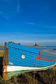 Boat On Shore With Lindesfarne Castle In Distance, Holy Island,Northumberland,Uk