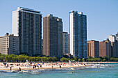 People At Oak Street Beach With High Rise Buildings In Background, Chicago,Illinois,Usa