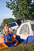 Man Setting Up Tent At Jetty Park
