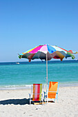Deckchairs And Umbrella On Beach