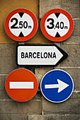 Road Signs Mounted On A Wall; Barcelona, Catalonia, Spain