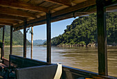 View Of A River From The Window Of A Tour Boat; Luang Prabang Province, Laos