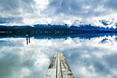 Clouds reflected in the tranquil ocean water off the coast of Tofino, Vancouver Island; Tofino, British Columbia, Canada