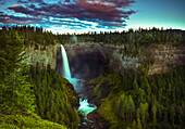 Beleuchteter Wasserfall, der über eine Klippe fließt, im Wells Grey Provincial Park; Thompson-Nicola Regional District, British Columbia, Kanada.