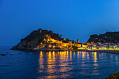 Night view from Tossa de Mar of Castell de Tossa, which was built in 1187; Tossa de Mar, Girona, Spain