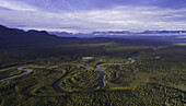 Aerial image of a stream with the mountains of Kluane National Park in the distance, near Haines Junction; Yukon Territory, Canada