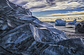 Jokulsarlon or Diamond Beach, with large chunks of ice littering the beach between each high tide; Iceland