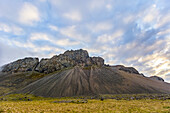 A rugged rocky mountain landscape at sunset in the summer; Iceland