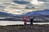 Two female travellers celebrate their hike and embrace the excitement of this beautiful nature viewpoint in Western Iceland; Iceland