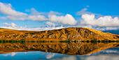 Mirror image of landscape into Lake Hayes; South Island, New Zealand