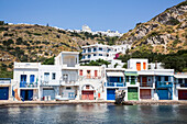 Klima village with white houses and colourful accents along the water's edge; Klima, Milos Island, Cyclades, Greece