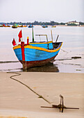 Colourful fishing boat tied to the beach, Ke Ga Cape; Ke Ga, Vietnam