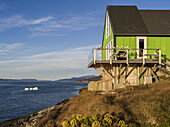 House in a bright green colour along the shore of Nuuk; Nuuk, Sermersooq, Greenland