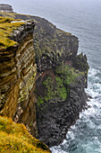 Rugged cliffs along the coast in mist, Snaefellsjokull National Park; Helgafellssveit, Western Region, Iceland