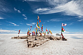 Flaggen der Länder, die an der Rallye Dakar in Bolivien teilnehmen, auf dem Salar de Uyuni, dem größten Salzsee der Welt; Departement Potosi, Bolivien.