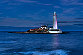 St Mary's Island Lighthouse illuminated at night on Whitley Bay; Tyne and Wear, Northumberland, England, United Kingdom