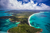 Aerial views over the Whitsunday Island chain. Whitehaven Beach is one of the most popular stops due to it's pure white silica beaches; Whitsundays, Queensland, Australia