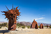 Exploring the 'Super Bloom' at Anza-Borrego Desert State Park, in Borrego, California. The RICARDO BRECEDA SCULPTURES in the Galleta Meadows is a major draw to the area. This is a unique sea serpent sculpture he created; Borrego Springs, California, United States of America