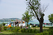 A group of travellers set up camp alongside of Lake Balaton for the day; Zamardi, Somogy County, Hungary