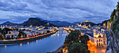 Österreichische Stadt Salzburg in der Abenddämmerung, der Fluss Salzach reflektiert die Lichter; Salzburg, Salzburg, Österreich
