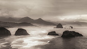 Scenic view of Cannon Beach with the famous rock formations and the Pacific Ocean in sepia tone; Oregon, United States of America