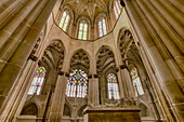 Interior of the chapel at the Batalha Monastery with the joint tomb of Joao I of Portugal and his queen, Philippa of Lancaster, surrounded by the ornate stonework of the central nave with its intricate stained glass windows; Batalha, District of Leiria, Centro Region, Portugal