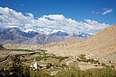 View from the Likir Monastery above the Indus Valley showing the landscape below with a whitewashed stupa, through the Himalayan Mountains of Ladakh, Jammu and Kashmir; Likir, Ladakh, India