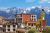 Rooftops of the Likir Monastery with its giant gold plated statue of a seated Buddha watching over from above the Indus Valley, in the Himalayan Mountains of Ladakh, Jammu and Kashmir; Likir, Ladakh, India